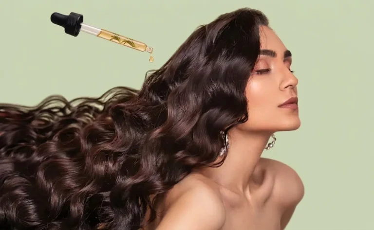 Cheveux longs et brillants sur fond vert clair, avec une pipette déposant une goutte d’huile de romarin dorée contenant une petite plante, illustrant un soin capillaire nourrissant.