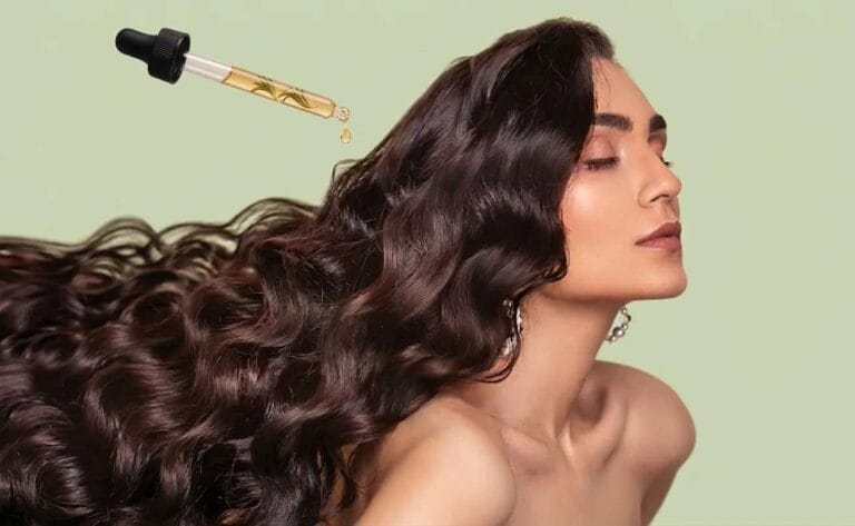 Cheveux longs et brillants sur fond vert clair, avec une pipette déposant une goutte d’huile de romarin dorée contenant une petite plante, illustrant un soin capillaire nourrissant.
